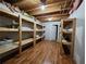 Unfinished basement featuring wood storage shelves and wood floors at 5619 Wandering Vine Se Ln, Mableton, GA 30126