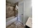 Bathroom featuring a tub with tiled walls and vinyl floors at 5619 Wandering Vine Se Ln, Mableton, GA 30126