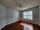 Bright bedroom featuring hardwood floors, fresh paint, and a modern ceiling fan at 5619 Wandering Vine Se Ln, Mableton, GA 30126