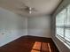 Bright bedroom featuring hardwood floors, fresh paint, and a modern ceiling fan at 5619 Wandering Vine Se Ln, Mableton, GA 30126