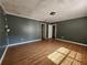 Spacious bedroom with laminate floors, window, and modern lighting at 5619 Wandering Vine Se Ln, Mableton, GA 30126