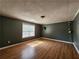 Spacious bedroom with laminate floors, window, and modern lighting at 5619 Wandering Vine Se Ln, Mableton, GA 30126