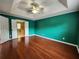 Large bedroom with tray ceilings, ceiling fan and hardwood floors at 5619 Wandering Vine Se Ln, Mableton, GA 30126