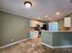Cozy kitchen featuring stainless steel appliances, white cabinets and travertine floors at 5619 Wandering Vine Se Ln, Mableton, GA 30126