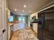 Well lit kitchen with stainless appliances and white cabinets at 5619 Wandering Vine Se Ln, Mableton, GA 30126