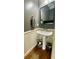Powder room with pedestal sink, wood floors and traditional beadboard at 1517 Gilstrap Nw Ln, Atlanta, GA 30318