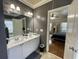 Elegant bathroom featuring a double sink vanity with modern fixtures and an open doorway to the bedroom at 1517 Gilstrap Nw Ln, Atlanta, GA 30318