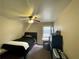 Cozy bedroom with black furnishings, carpeted floors, and a ceiling fan at 1517 Gilstrap Nw Ln, Atlanta, GA 30318