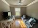 Well-lit loft space featuring a comfortable sofa, a work desk, and ample natural light from the window at 1517 Gilstrap Nw Ln, Atlanta, GA 30318