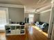 Cozy loft area with hardwood floors, a gray sofa, and built-in shelving, creating a versatile living space at 1517 Gilstrap Nw Ln, Atlanta, GA 30318