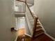 Staircase with wood treads and white risers, offering a view of the upper floor and a glimpse of natural light at 1517 Gilstrap Nw Ln, Atlanta, GA 30318