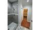 Walk-in shower featuring tile surround and a decorative floor provides a luxurious feel at 1713 Cagle Ct, Lawrenceville, GA 30045