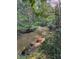Scenic view of a tranquil creek surrounded by lush greenery and mature trees at 1713 Cagle Ct, Lawrenceville, GA 30045