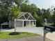 Charming home with inviting front porch, modern gray siding, and a large, paved driveway at 1713 Cagle Ct, Lawrenceville, GA 30045