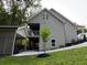 Side view of a modern home with a covered patio, lush landscaping, and a gray exterior at 1713 Cagle Ct, Lawrenceville, GA 30045