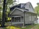Side view of a two-story home with a covered parking and second-story deck, surrounded by trees at 1713 Cagle Ct, Lawrenceville, GA 30045