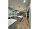 Bright kitchen features an expansive island, wood floors, and white cabinetry with stainless appliances at 1713 Cagle Ct, Lawrenceville, GA 30045