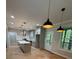 Modern kitchen features a central island, stainless appliances, and elegant pendant lighting at 1713 Cagle Ct, Lawrenceville, GA 30045