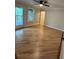 Bright living room with hardwood floors and ceiling fan, leading to a covered outdoor space at 1713 Cagle Ct, Lawrenceville, GA 30045