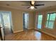 Bright living room with hardwood floors and ceiling fan, leading to a covered outdoor space at 1713 Cagle Ct, Lawrenceville, GA 30045