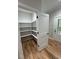 Walk-in pantry with custom shelving provides organized storage off of the kitchen at 1713 Cagle Ct, Lawrenceville, GA 30045