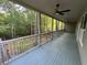 Expansive covered porch with ceiling fans offers serene views of the surrounding woods at 1713 Cagle Ct, Lawrenceville, GA 30045
