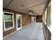 Spacious covered porch with wood plank floors, natural views, and multiple access doors, perfect for outdoor living at 1713 Cagle Ct, Lawrenceville, GA 30045