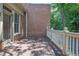Side exterior of house featuring a wood balcony with a brick exterior and a view to trees at 2010 Riverside Rd, Roswell, GA 30076