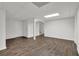 Finished basement with wood floors, white walls, drop ceiling and recessed lighting at 2010 Riverside Rd, Roswell, GA 30076