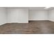 Finished basement with wood flooring and white trim provides a flexible living space at 2010 Riverside Rd, Roswell, GA 30076