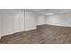 Finished basement with wood floors, white walls, and closet with bi-fold doors at 2010 Riverside Rd, Roswell, GA 30076