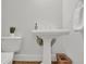 This bathroom features a pedestal sink and matching toilet at 2010 Riverside Rd, Roswell, GA 30076