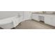 Bathroom with classic clawfoot tub, tile floors, a double sink vanity, and white cabinets at 2010 Riverside Rd, Roswell, GA 30076