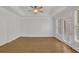 A bright and airy bedroom with hardwood floors, white trim, and a door to a balcony at 2010 Riverside Rd, Roswell, GA 30076