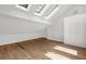 Bright bonus room featuring hardwood floors, skylights, and built-in storage at 2010 Riverside Rd, Roswell, GA 30076