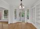 Bright dining room with hardwood floors, white trim, a stylish chandelier, and a view to the sunroom at 2010 Riverside Rd, Roswell, GA 30076
