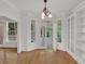 Bright dining area featuring hardwood floors, classic lighting, and glass doors leading to sunroom and deck at 2010 Riverside Rd, Roswell, GA 30076