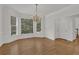 Elegant dining room with hardwood floors, chandelier, and large windows offering scenic views at 2010 Riverside Rd, Roswell, GA 30076