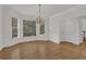 Bright dining room features hardwood floors, large windows and chandelier lighting at 2010 Riverside Rd, Roswell, GA 30076