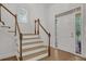 Bright entryway featuring hardwood floors, stairway, and a stylish door with decorative glass at 2010 Riverside Rd, Roswell, GA 30076