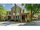 Charming brick townhome with a covered porch and landscaped front yard in a desirable neighborhood at 2010 Riverside Rd, Roswell, GA 30076