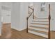 Bright foyer with hardwood floors, staircase, chandelier, and access to multiple rooms at 2010 Riverside Rd, Roswell, GA 30076