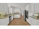 Beautiful kitchen with white cabinets, granite countertops, stainless steel appliances, and hardwood floors at 2010 Riverside Rd, Roswell, GA 30076