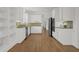Spacious kitchen with white cabinetry, stainless steel appliances, and hardwood floors at 2010 Riverside Rd, Roswell, GA 30076