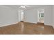 Large living room with hardwood floors, ceiling fan, and views to other rooms at 2010 Riverside Rd, Roswell, GA 30076