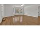 Spacious living room with hardwood floors, bay window, and modern ceiling fan at 2010 Riverside Rd, Roswell, GA 30076
