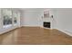 Bright living room with hardwood floors, built-in shelving, fireplace, and large windows at 2010 Riverside Rd, Roswell, GA 30076