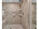 Close up of tiled shower with built-in bench, glass door, and updated shower head at 2010 Riverside Rd, Roswell, GA 30076