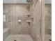 A tiled walk-in shower with glass door featuring a built in bench and shower head at 2010 Riverside Rd, Roswell, GA 30076