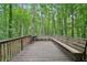 Large wooden deck perfect for outdoor living, featuring a grill and bench seating at 4772 Ridgewood Nw Ct, Acworth, GA 30102